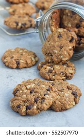 Flourless Gluten Free Peanut Butter, Oatmeal And Chocolate Chips Cookies In Glass Jar And On Table, Vertical