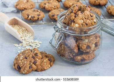 Flourless Gluten Free Peanut Butter, Oatmeal And Chocolate Chips Cookies In Glass Jar And On Table, Horizontal