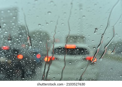 Flow Down Raindrops On Windscreen With Blur Bokeh From The Light Of The  Car Outside 