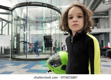 Flow Moscow, Moscow, Russia - 24th April, 2021: Indoor Activity. Portrait Of Cute Boy With A Skydiving Helmet Standing In Front Of Indoor Wind Tunnel.