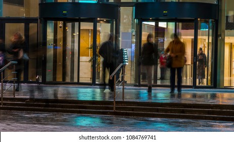  The Flow Of People Passing Through The Revolving Door Of The Office Building At The End Of The Working Day