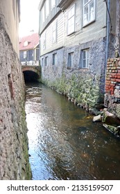 the flow of the river between the buildings of the old town