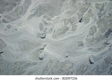 Flow Of Rocky Silt Stream In Mud Of Alaska.