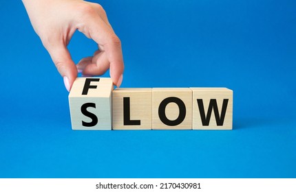 Flow and Slow symbol. Concept words Flow and Slow on wooden cubes. Beautiful blue background. Businessman hand. Business and Flow and Slow concept. Copy space. - Shutterstock ID 2170430981