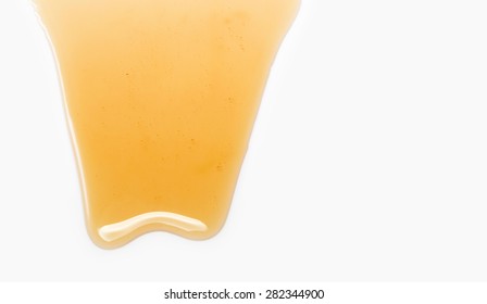 Flow Of Sweet Honey On The White Background