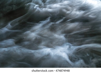 The Flow Of Thick Smoke On A Dark Background