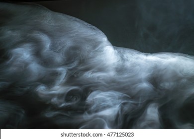 The Flow Of Thick Smoke On A Dark Background