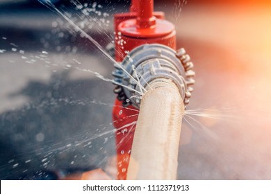 The Flow Of Water And Puddles From An Open Fire Hydrant