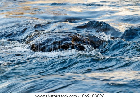 flow of water and spray from a stone close up