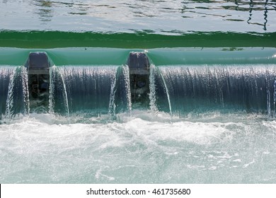 The flow of water through the weir in the side stream of the river Reuss forms a small waterfall in Lucerne in Switzerland