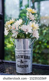 Flower In Aluminium Pot On Black Steel Shelves