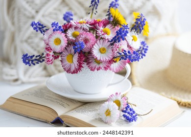 Flower arrangement with daisy and other summer flowers in a white cup. Spring floral composition. Greeting postcard for Mother's or Women's day, birthday, anniversary. Cozy atmosphere - Powered by Shutterstock