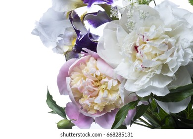 Flower arrangement of peonies and irises. Pink background.