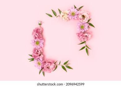 Flower Border Frame Made Of Eustoma On A Pink Pastel Background. Greeting Card Template With Copyspace.