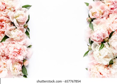 Flower border frame made of pink and beige buds peony bouquet on a white background. The apartment lay, top view. Floral texture background.
