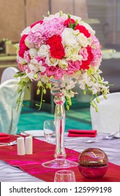 Flower bouquet in glass vase on dining table
