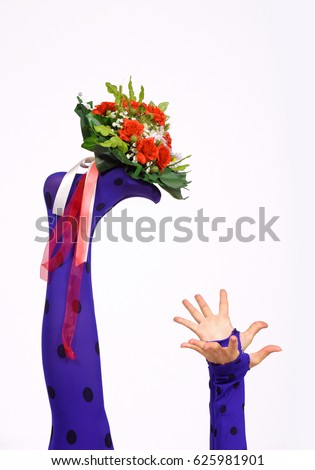 A flower bouquet is held up high by two feet in blue polka dot stockings. 
Wide opened hands try to catch the bouquet in front of a white background. 