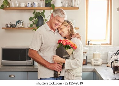 Flower bouquet, hug and senior couple with smile for celebration of marriage in kitchen of their house. Elderly man and woman giving roses as gift while hugging for love, anniversary or birthday - Powered by Shutterstock