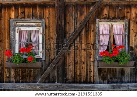 Flower boxes on an old house made of wood in Austria in Defereggental, Tyrol
