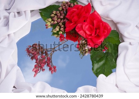 Flower and cloud mirror reflection demonstration of cosmetic products still life