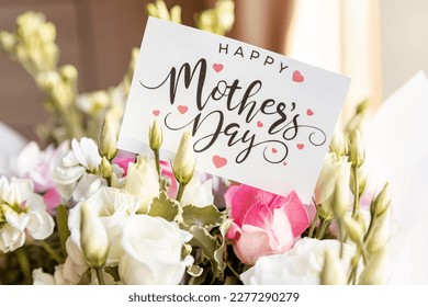 flower composition of light roses and eustoma closeup. Text Happy mother's day. Bright bouquet with tender flowers.Greetings card,sweet wish concept.