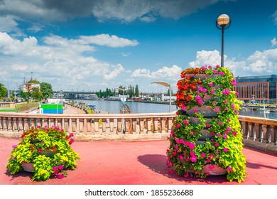 Flower decoration on Long Bridge, called Most Dlugi and view on Wieleckie Quay in Szczecin, Poland. Promenade and boulevards on Odra River embarkment - Shutterstock ID 1855236688