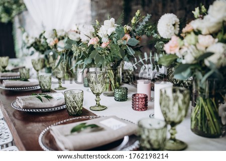 Flower decoration of wedding tables.
Banquet table setting and decoration. Cutlery on the table. 