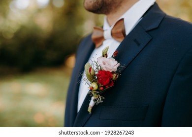 Flower Detail On The Lapel Of The Groom's Blue Suit