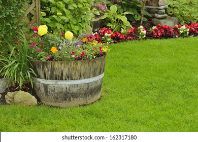 Flower Garden. A Barrel Arrangement Full Of Annuals And Perennials.