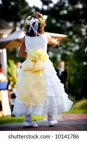 Flower Girl Dropping Rose Petals During A Wedding