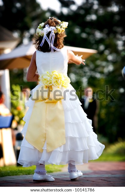 flower girl dropping petals