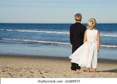 Flower Girl And Ring Bearer On The Beach After A Wedding.