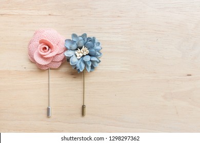 Flower Lapel Pins On Wooden Background