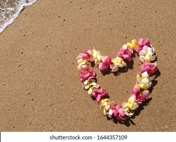 Flower Lei On Sandy Beach