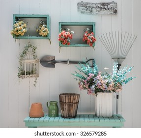 Flower On Green Bench With White Wood Panel Wall In Garden