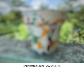 Flower Pot With A White Base Color And Then Given Colorful Splashes Defocused