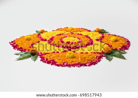 Flower Rangoli for Diwali or Pongal Festival made using Marigold or Zendu flowers and Rose petals over white background, selective focus
