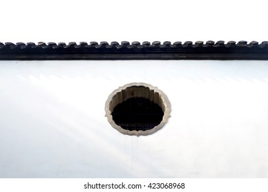 flower -shape window in a white wall