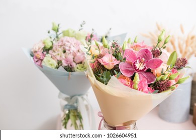 flower shop concept. Close-up beautiful lovely bouquet of mixed flowers on wooden table. Wallpaper