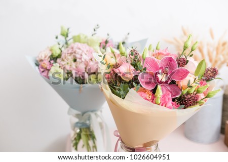 flower shop concept. Close-up beautiful lovely bouquet of mixed flowers on wooden table. Wallpaper