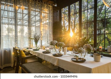 Flower, Spoon And Fork, Table Set Up For Dinner In Luxury Elegance Restaurant, With Sunlight Pass Through The Window.