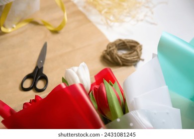 Flower template. Composition with flowers and scissors on craft paper. Tulips flowers, scissors and rope on a craft paper background. Out of focus. - Powered by Shutterstock