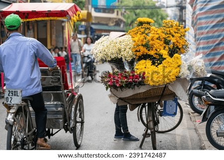 Flower vendor on Hanoi old town street at early morning
