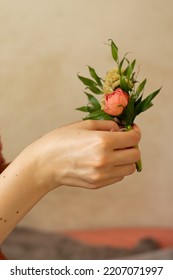 Flower weaving, woman's hand holding a woven flower arrangement - Shutterstock ID 2207071997