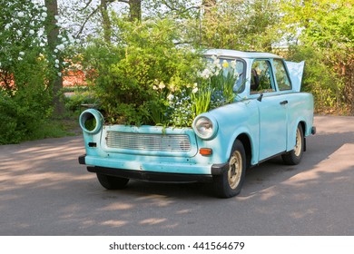 Flowerbed in an old small neo mint, biscay green color car as garden decoration in rustic style - Powered by Shutterstock