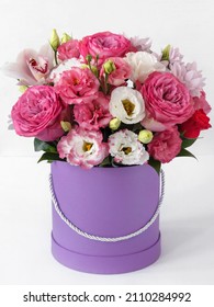 flowers in a box on a white background, close-up with a blurred background, pink roses, eustoma, orchid, chrysanthemums, as a gift for Valentine's day. a bouquet of flowers in a delicate pink color - Shutterstock ID 2110284992