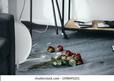 Flowers And Broken Vase On Floor In Robbed Apartment