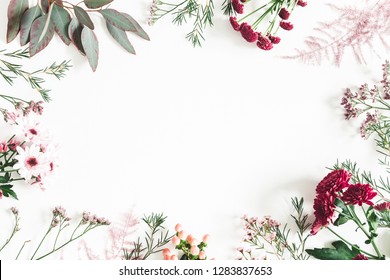 Flowers composition. Eucalyptus leaves and pink flowers on white background. Flat lay, top view