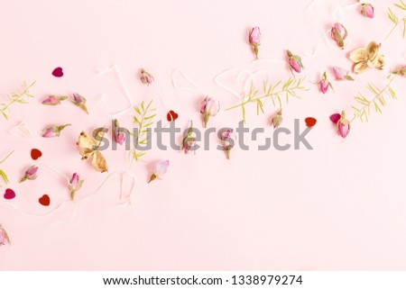 Flowers composition. Frame made of dried rose flowers on pink background.