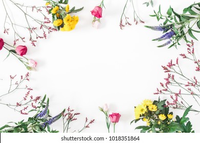 Flowers composition. Frame made of various colorful flowers on white background. Flat lay, top view, copy space